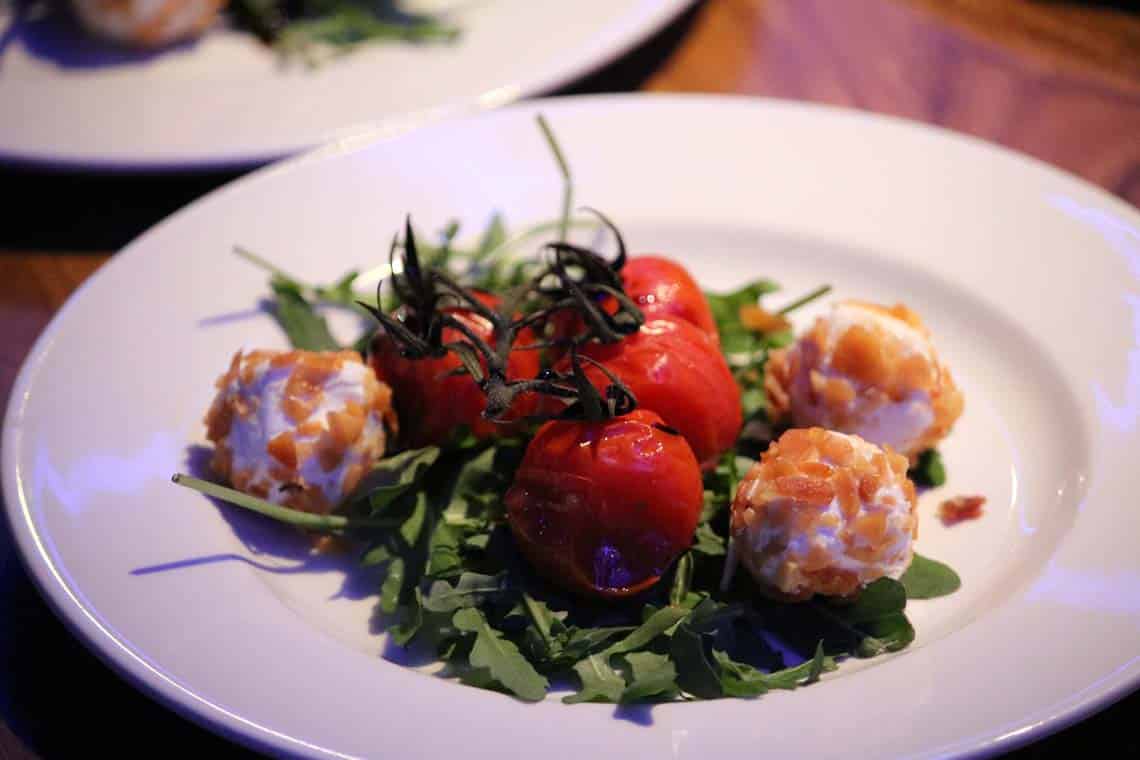 Almond Rolled Goats Cheese on Roquette, Roasted Cherry Tomatoes